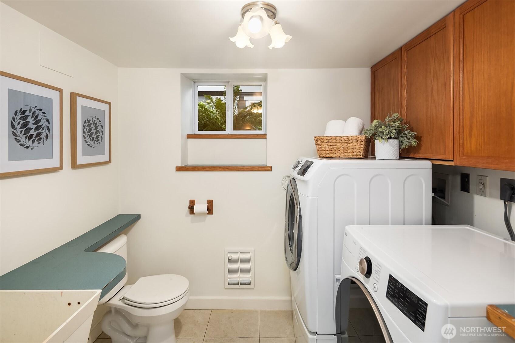 5722 Keystone Place North Seattle, WA 98103 - Photo 29 of 38 a bathroom with a sink a toilet and mirror