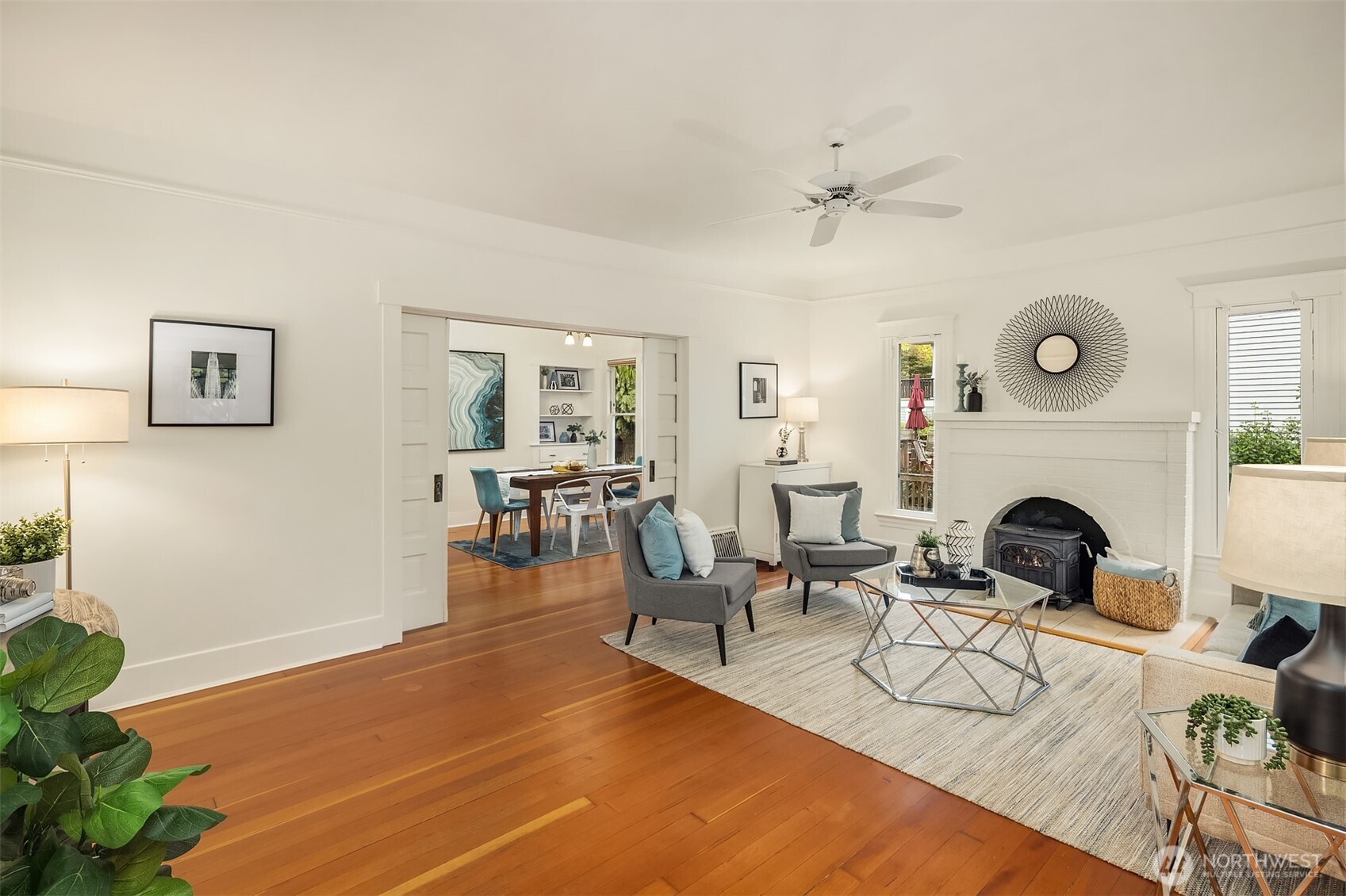 5722 Keystone Place North Seattle, WA 98103 - Photo 3 of 38 a living room with furniture a fireplace and wooden floor