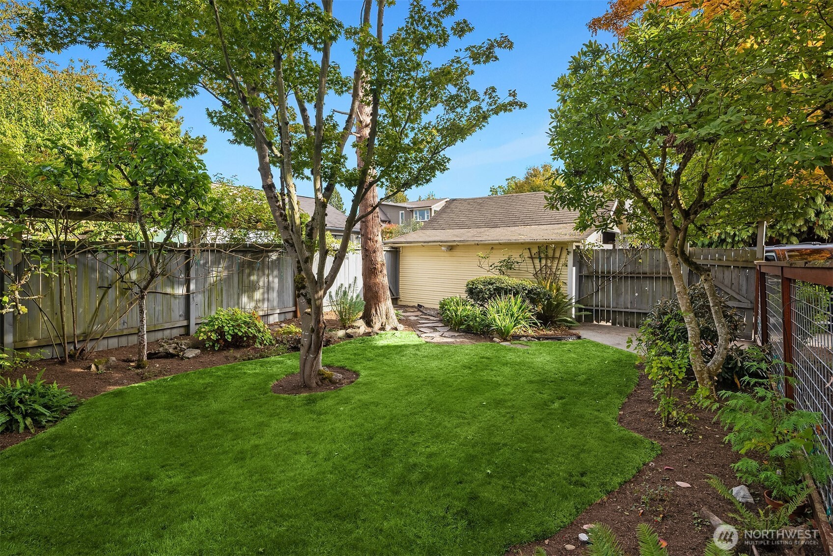 5722 Keystone Place North Seattle, WA 98103 - Photo 34 of 38 a garden with trees in front of it