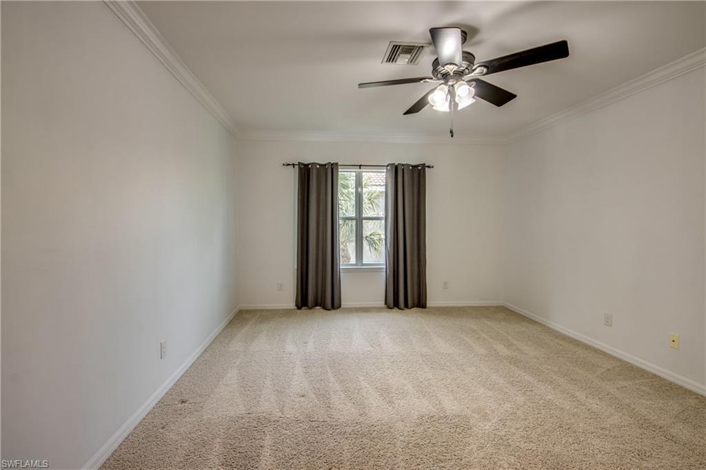 19530 Bowring Park Road, Unit 106 Fort Myers, FL 33967 - Photo 13 of 39 an empty room with chandelier fan and windows