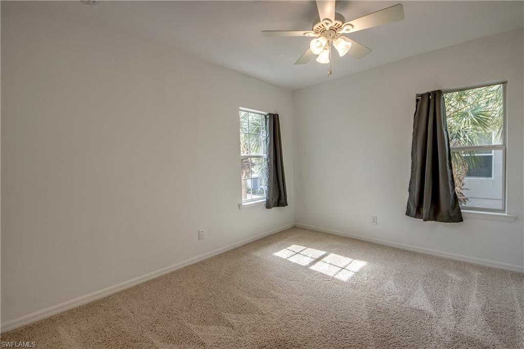 19530 Bowring Park Road, Unit 106 Fort Myers, FL 33967 - Photo 22 of 39 an empty room with windows and fan