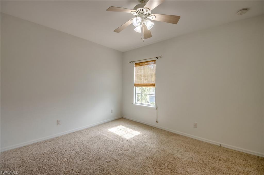 19530 Bowring Park Road, Unit 106 Fort Myers, FL 33967 - Photo 25 of 39 an empty room with a window and a fan