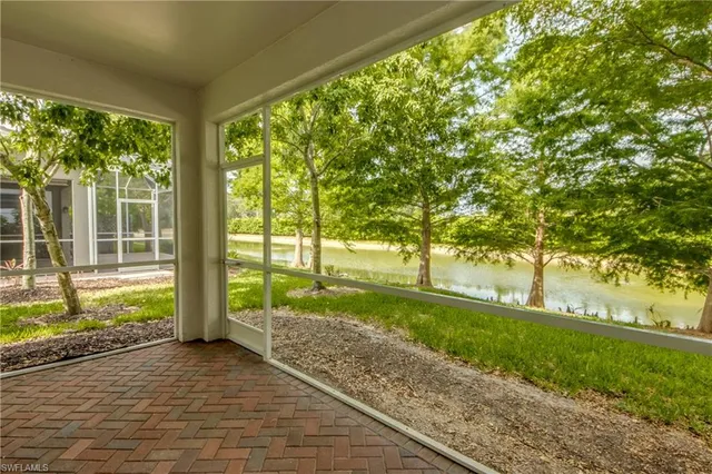 a view of yard with green space and trees all around