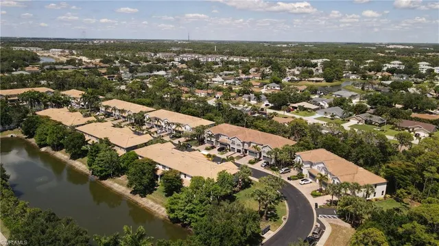 an aerial view of a residential houses with city view