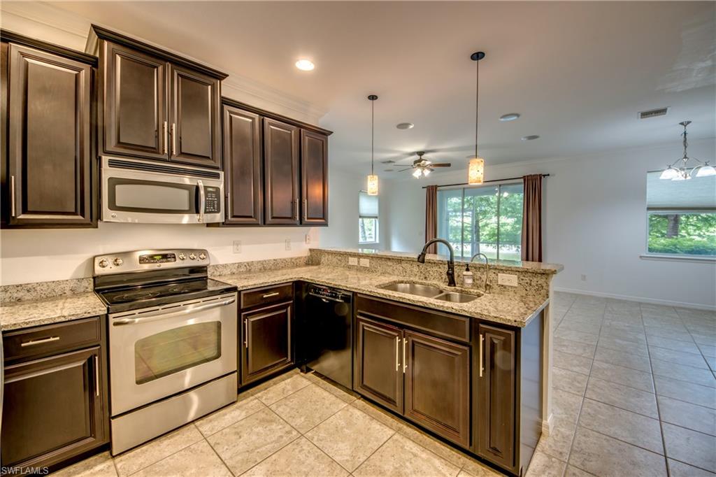 19530 Bowring Park Road, Unit 106 Fort Myers, FL 33967 - Photo 9 of 39 a kitchen with stainless steel appliances granite countertop a sink stove and refrigerator