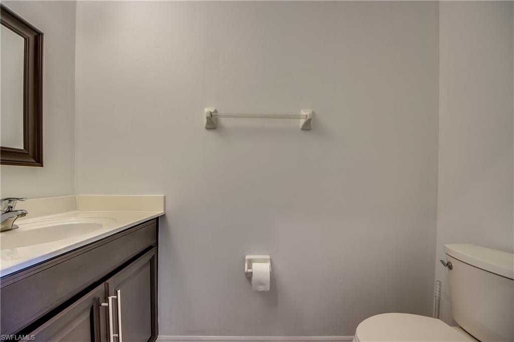 19530 Bowring Park Road, Unit 106 Fort Myers, FL 33967 - Photo 10 of 39 a bathroom with a sink mirror vanity and toilet