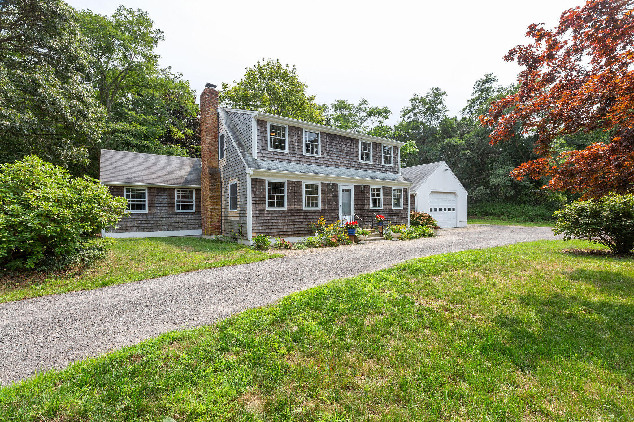 9 South Highland Road Truro, MA 02666 - Photo 1 of 32 a front view of a house with garden and porch