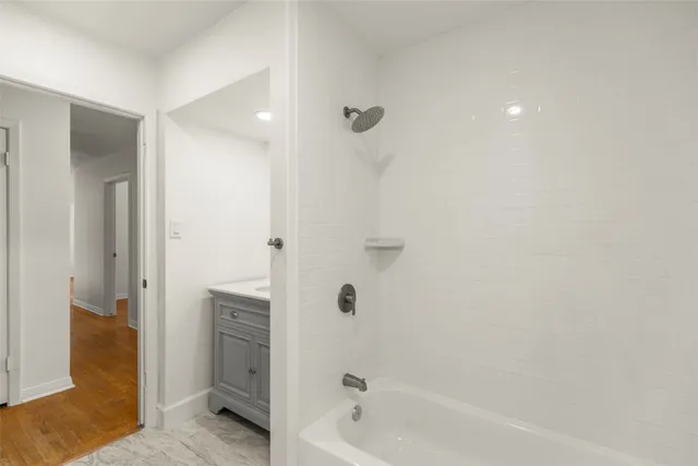 a bathroom with a bathtub and a shower