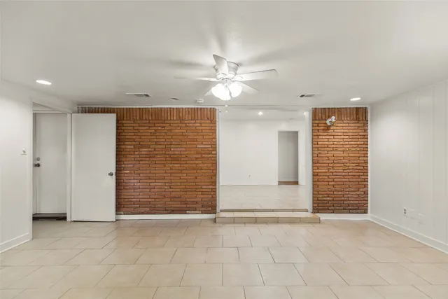 an empty room with closet and a ceiling fan