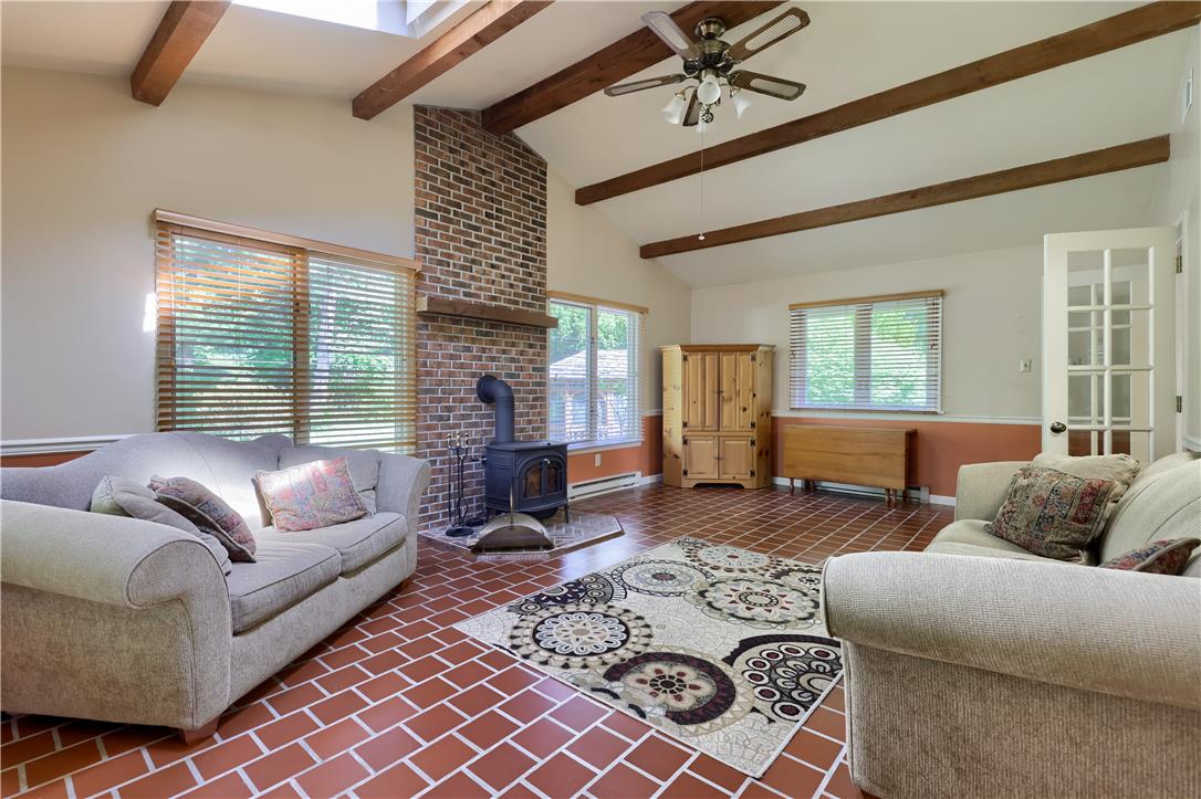 Coldsprings Rd Union Pottstown, PA 19465 - Photo 53 of 71 A rustic-inspired living area features exposed wood beams, brick accents, and durable tiled flooring.