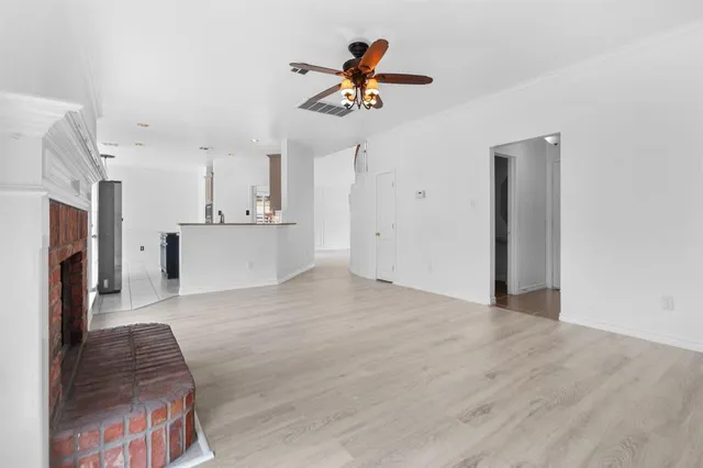 a view of open kitchen with cabinets and stainless steel appliances