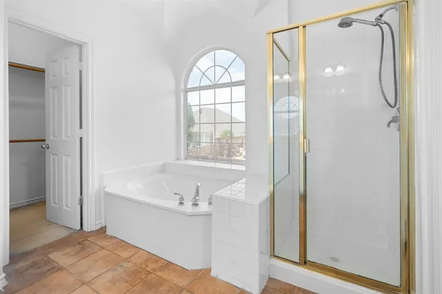 a bathroom with a bathtub and a shower