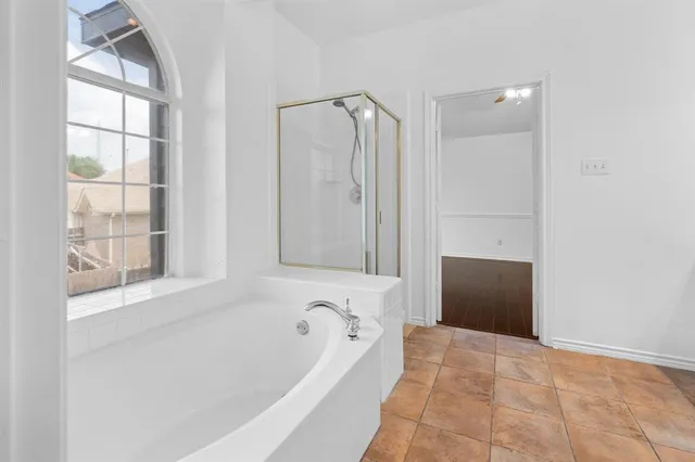 a bathroom with a bathtub and a shower