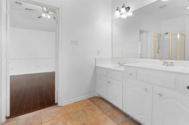 a bathroom with a sink vanity and mirror