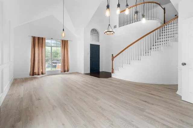 a view of an entryway with wooden floor