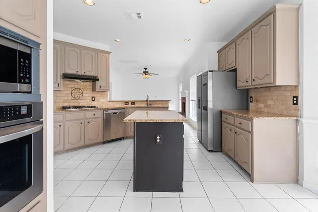a kitchen with a cabinets and steel stainless steel appliances