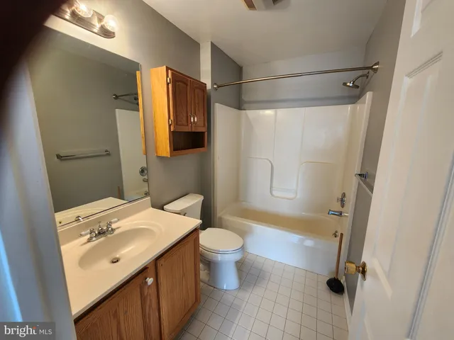 a bathroom with a sink mirror vanity and toilet