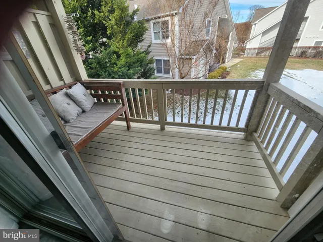 a view of a balcony with wooden floor