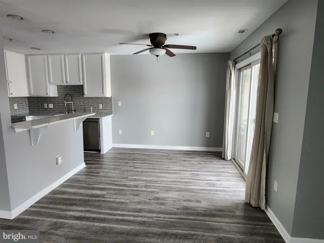 a view of a kitchen with a sink and cabinets
