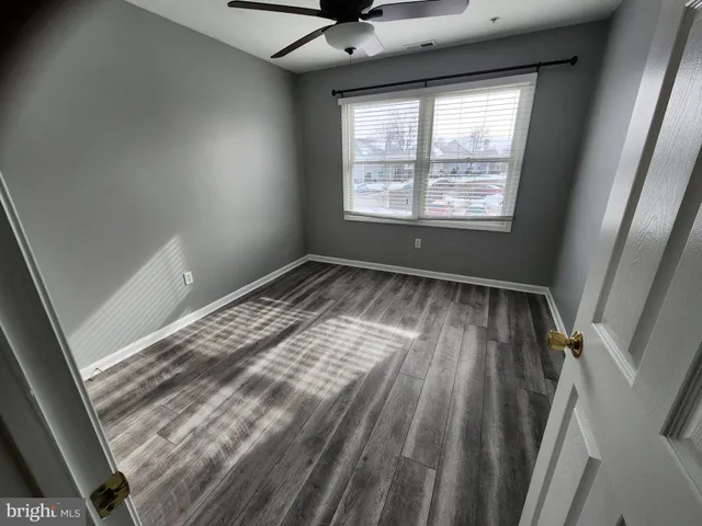 a view of room with window and hardwood floor