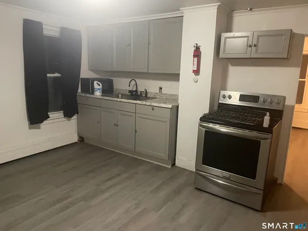 a kitchen with cabinets and steel stainless steel appliances