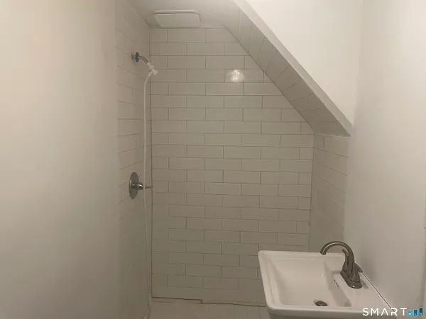 a bathroom with a sink and shower