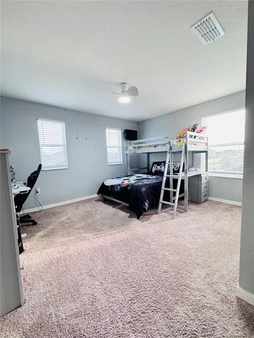 a bedroom with furniture and a chandelier