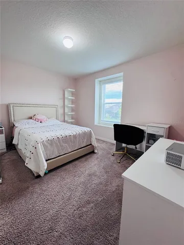 a bedroom with a bed and a table in it