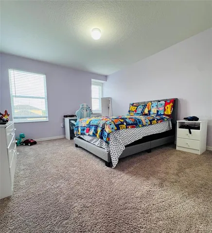 a bedroom with bed and a window