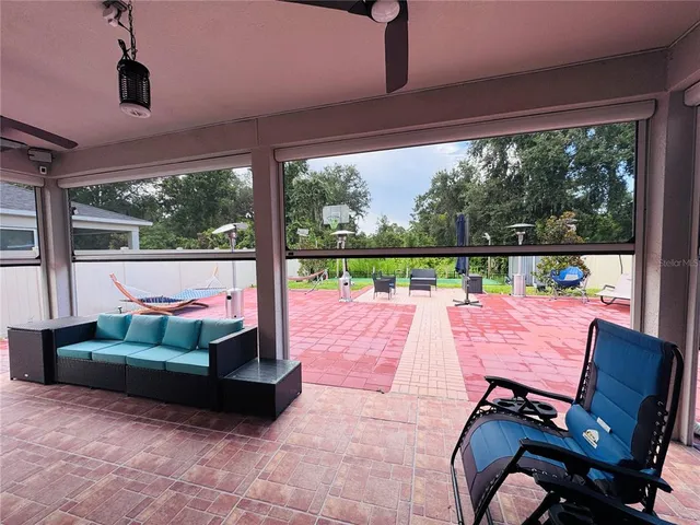 a sitting area with furniture and a garden view