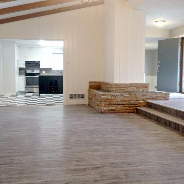 3313 45th Street Lubbock, TX 79413 - Photo 4 of 10 a view of kitchen with stainless steel appliances wooden floor and chandelier