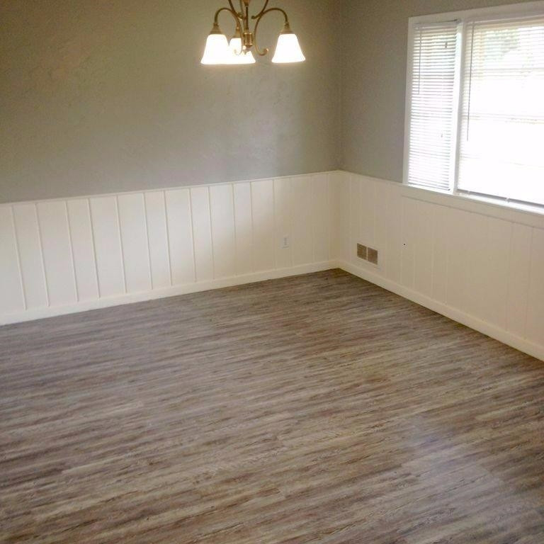 3313 45th Street Lubbock, TX 79413 - Photo 6 of 10 an empty room with wooden floor and windows