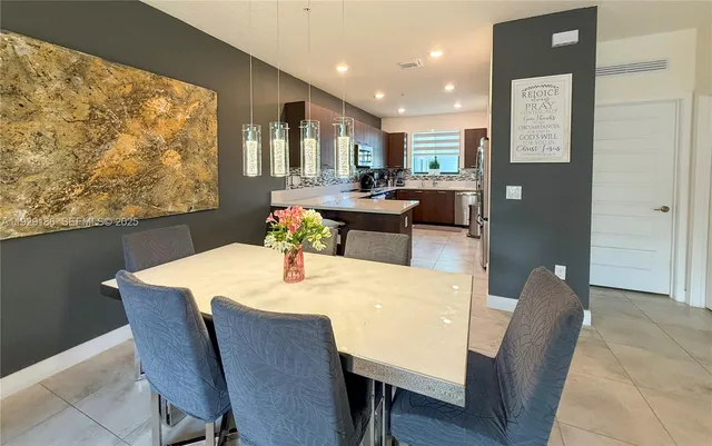 a kitchen with stainless steel appliances a refrigerator and a stove top oven