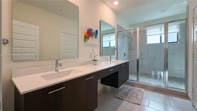 a bathroom with a sink a toilet a vanity and a window