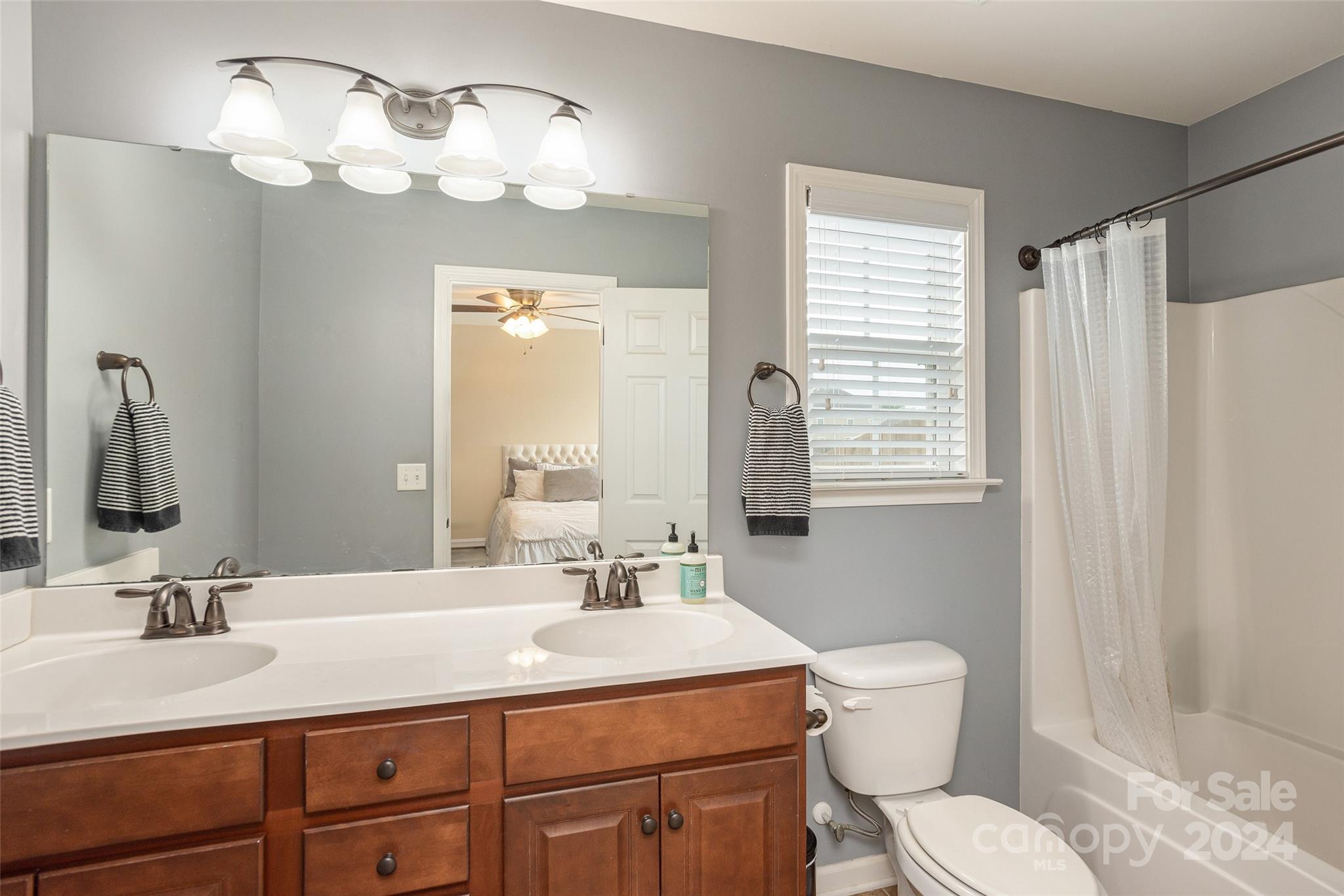48 East Hiawassee Road Fletcher, NC 28732 - Photo 12 of 20 a bathroom with a sink vanity mirror and toilet