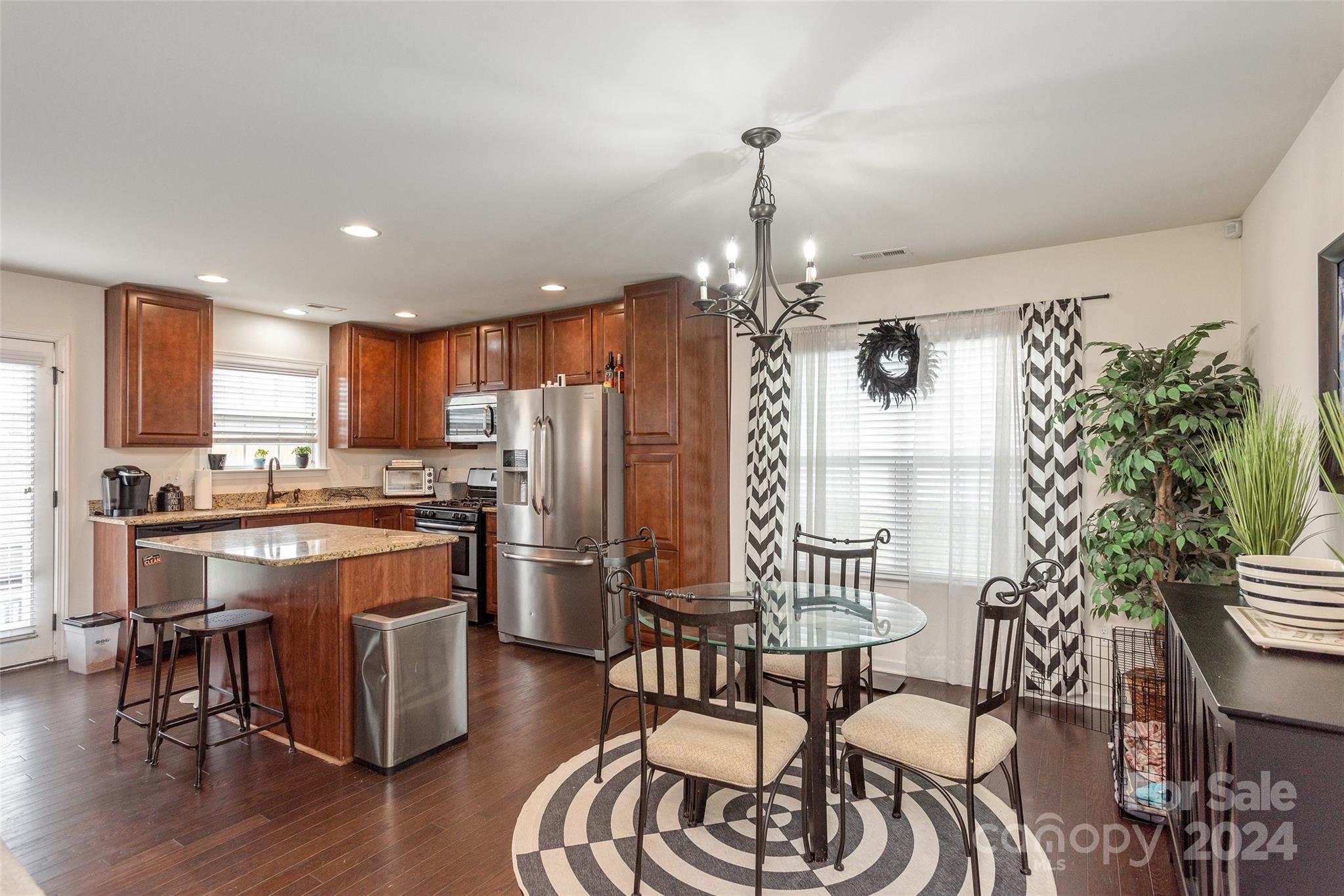 48 East Hiawassee Road Fletcher, NC 28732 - Photo 6 of 20 a kitchen with stainless steel appliances granite countertop a table chairs stove and refrigerator