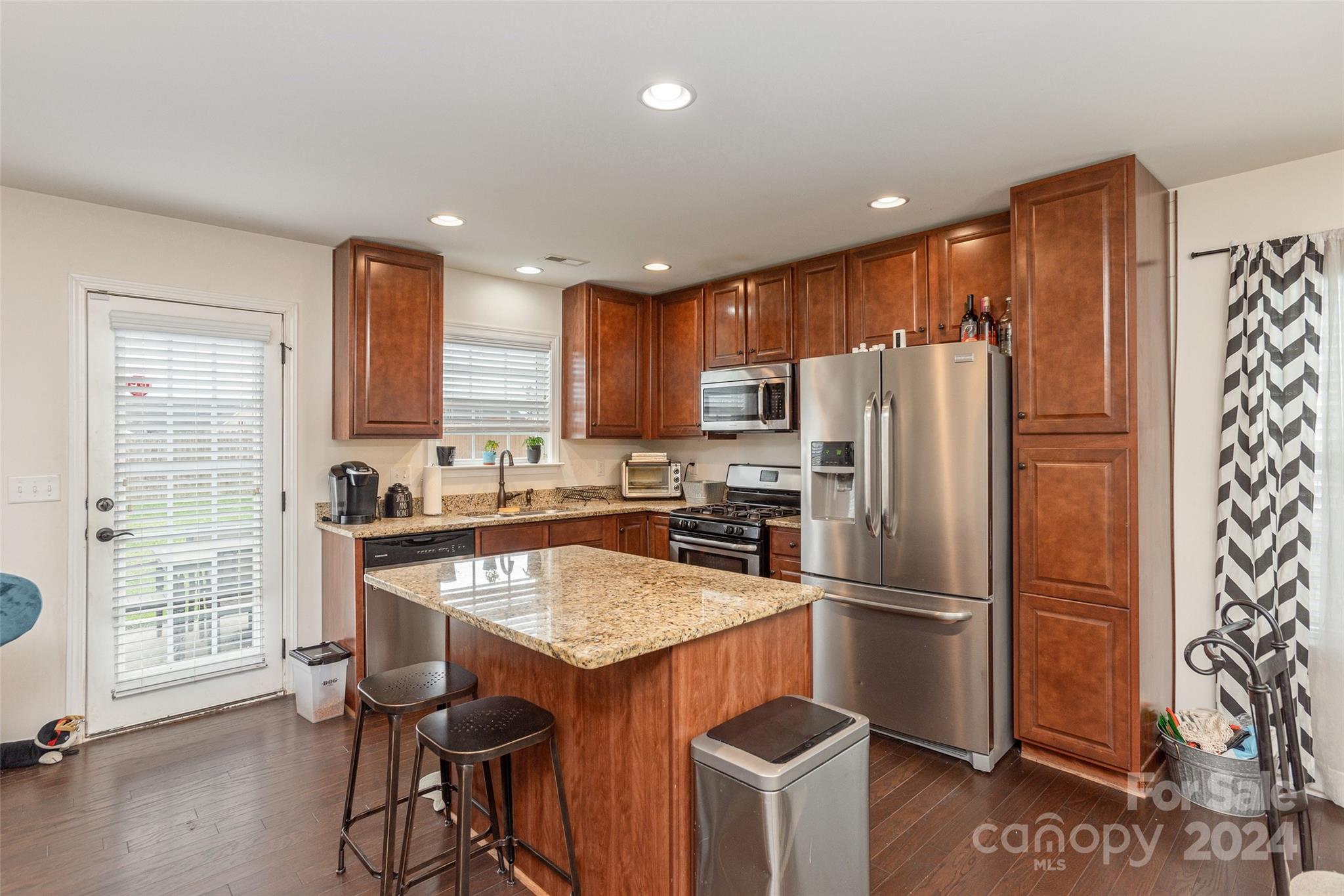 48 East Hiawassee Road Fletcher, NC 28732 - Photo 7 of 20 a kitchen with granite countertop a refrigerator and a stove top oven