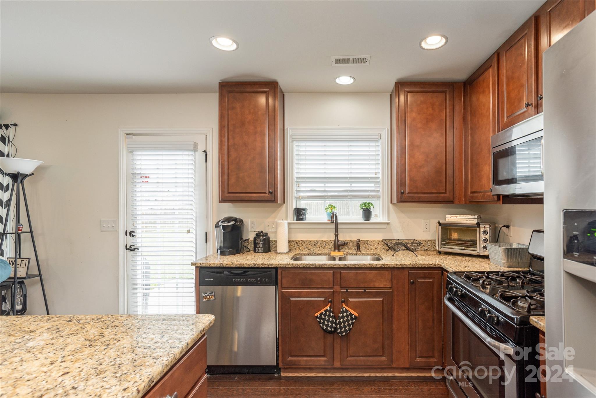 48 East Hiawassee Road Fletcher, NC 28732 - Photo 8 of 20 a kitchen with stainless steel appliances granite countertop a sink stove and refrigerator