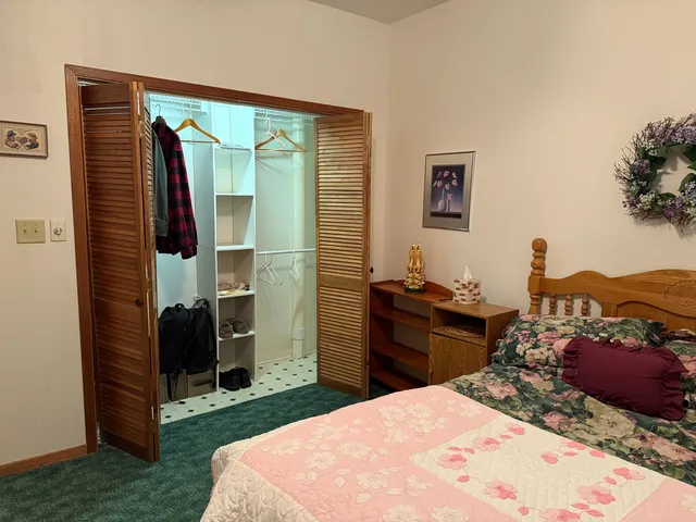 a bed room with a bed and a television