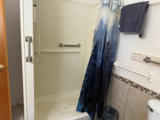 a bathroom with a bathtub and shower