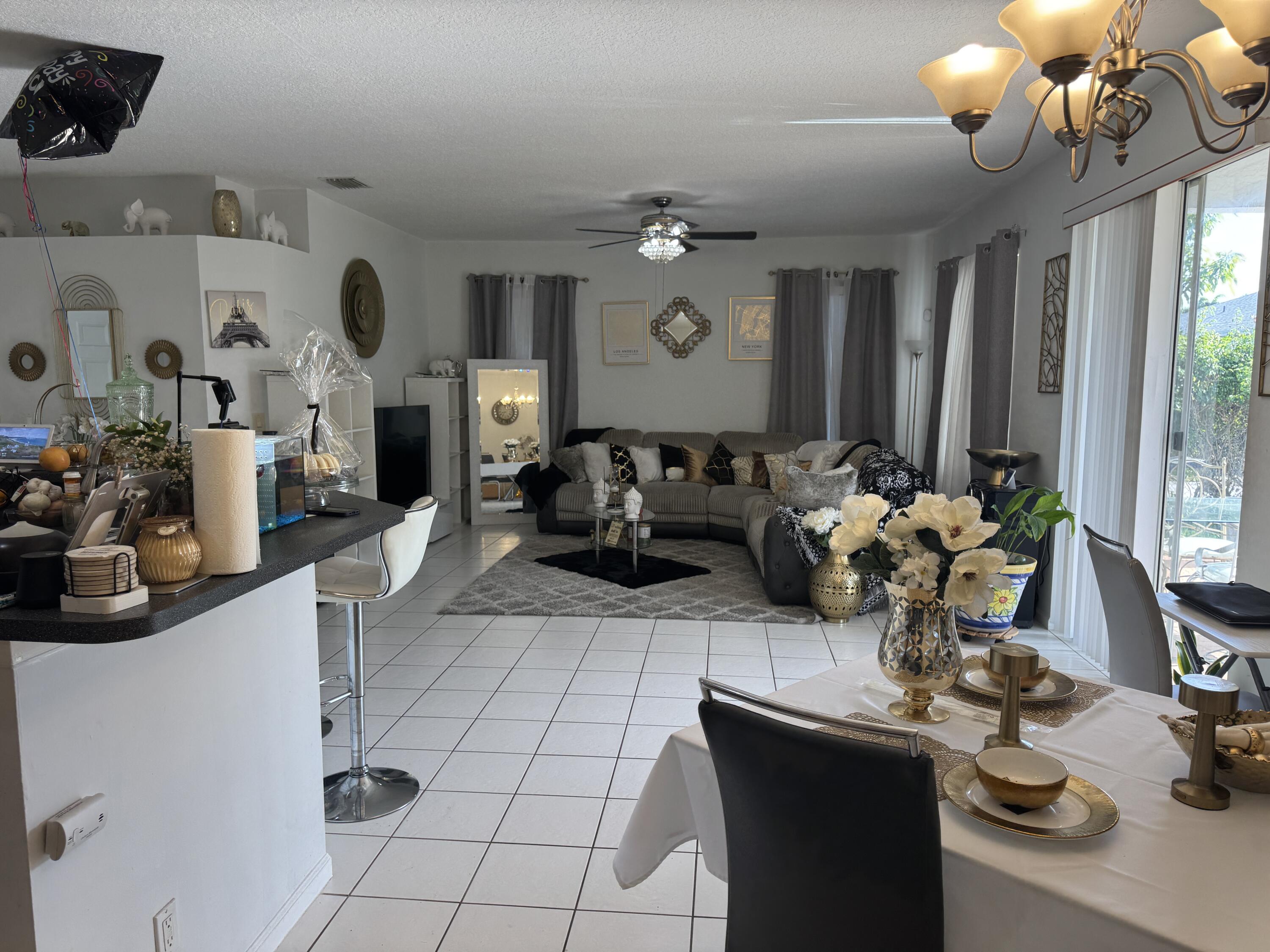 1011 Salmon Isle Greenacres, FL 33413 - Photo 12 of 28 a living room with fireplace furniture and a flat screen tv