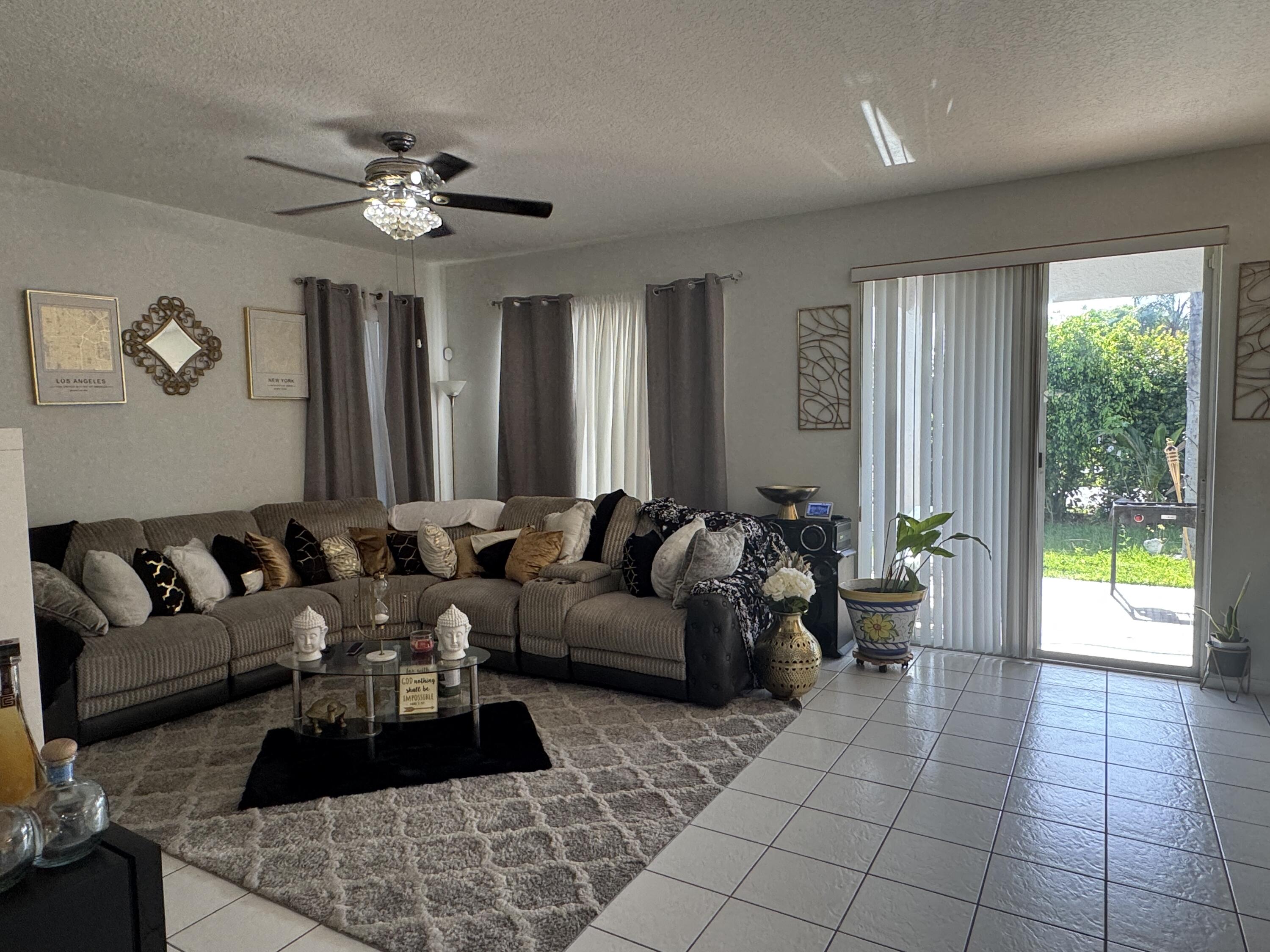 1011 Salmon Isle Greenacres, FL 33413 - Photo 14 of 28 a living room with furniture and a large window