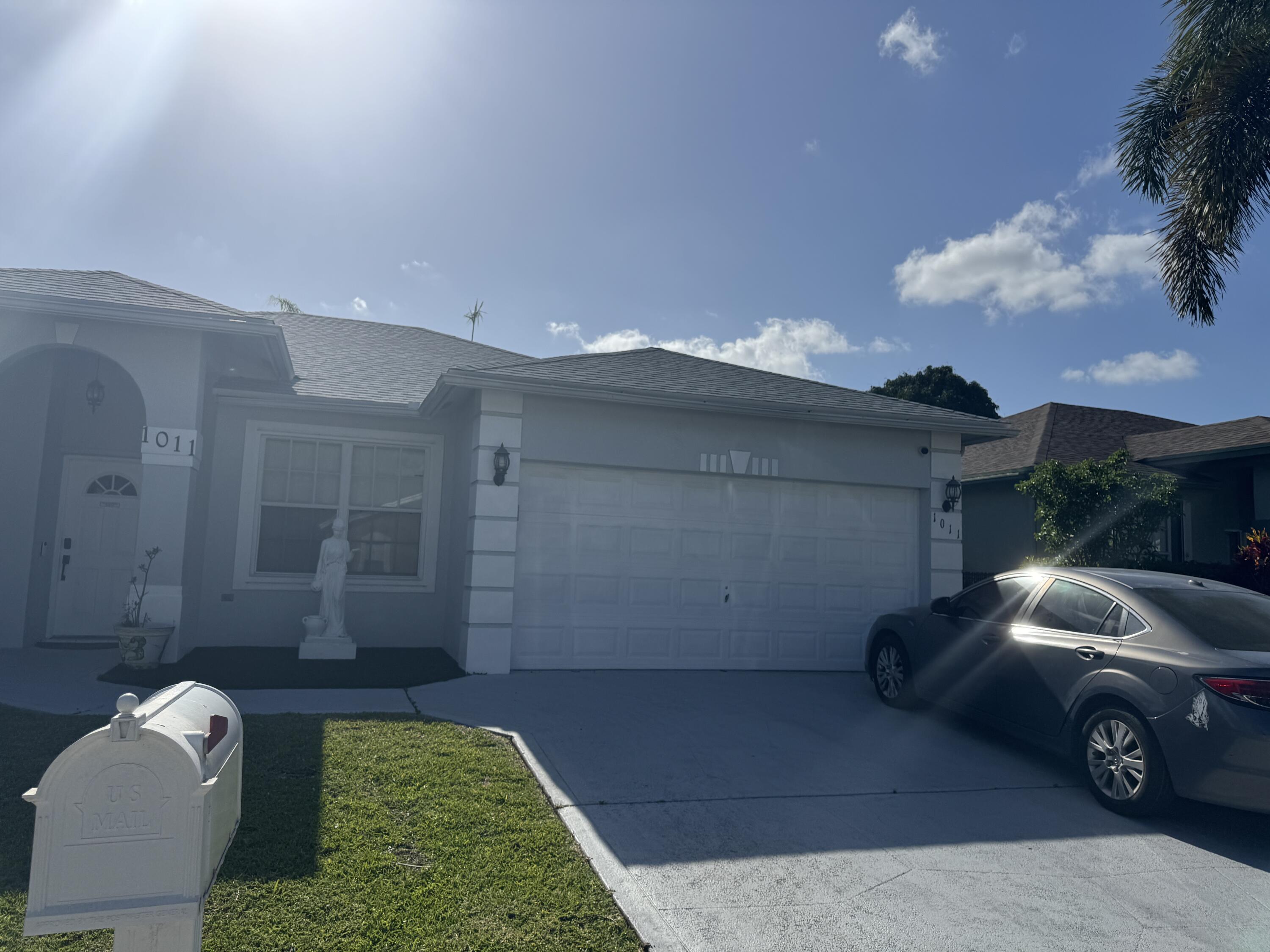 1011 Salmon Isle Greenacres, FL 33413 - Photo 2 of 28 a view of a car in front of a house