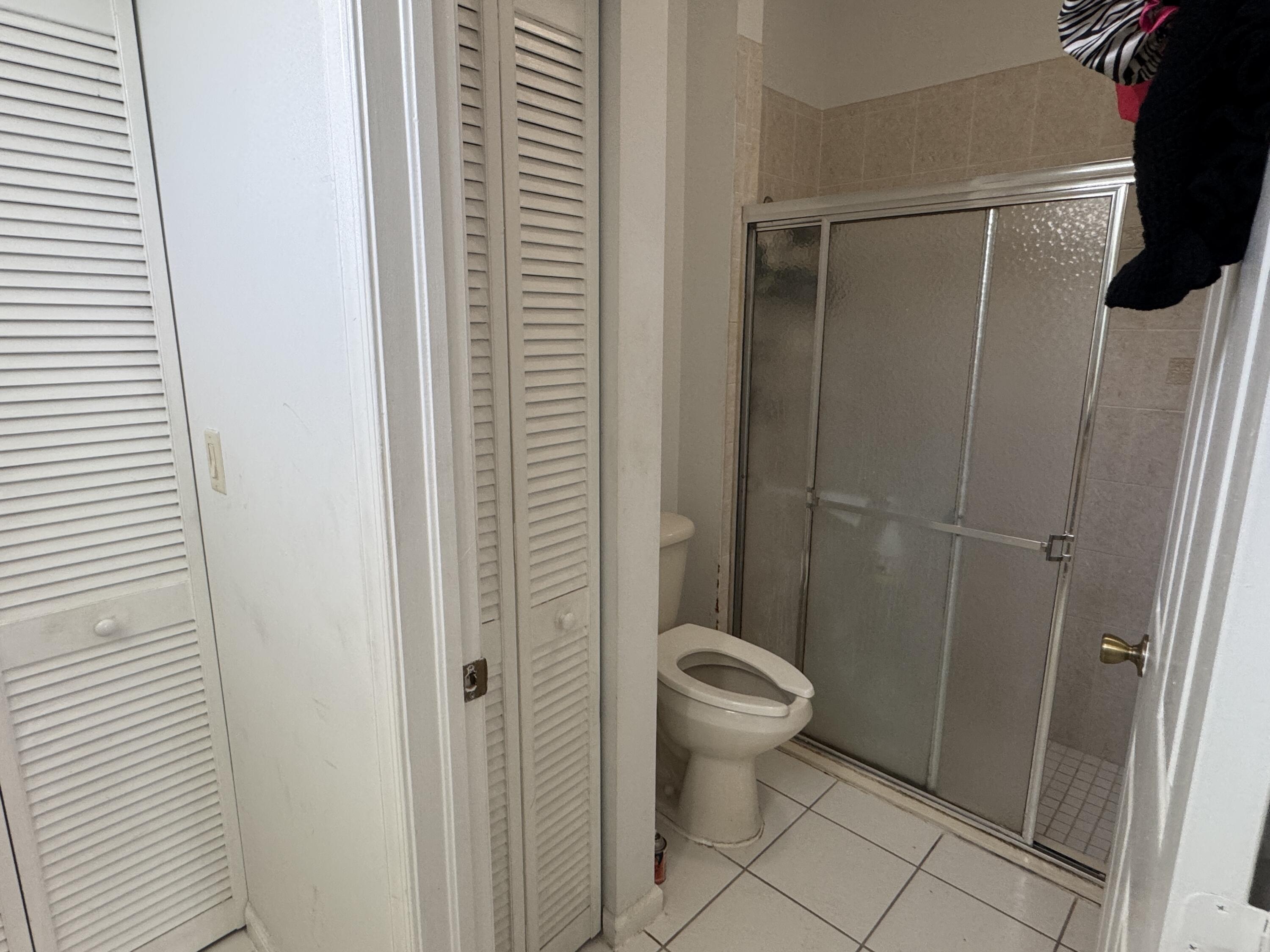 1011 Salmon Isle Greenacres, FL 33413 - Photo 24 of 28 a bathroom with a shower and a toilet