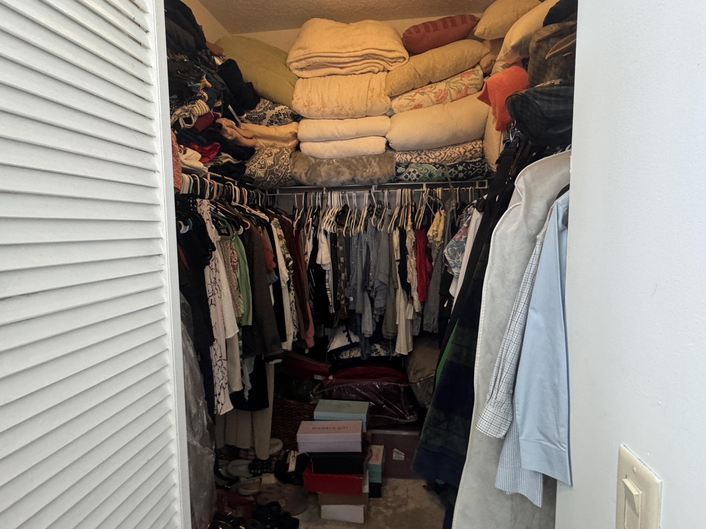 1011 Salmon Isle Greenacres, FL 33413 - Photo 25 of 28 a view of walk in closet with clothes and shoes