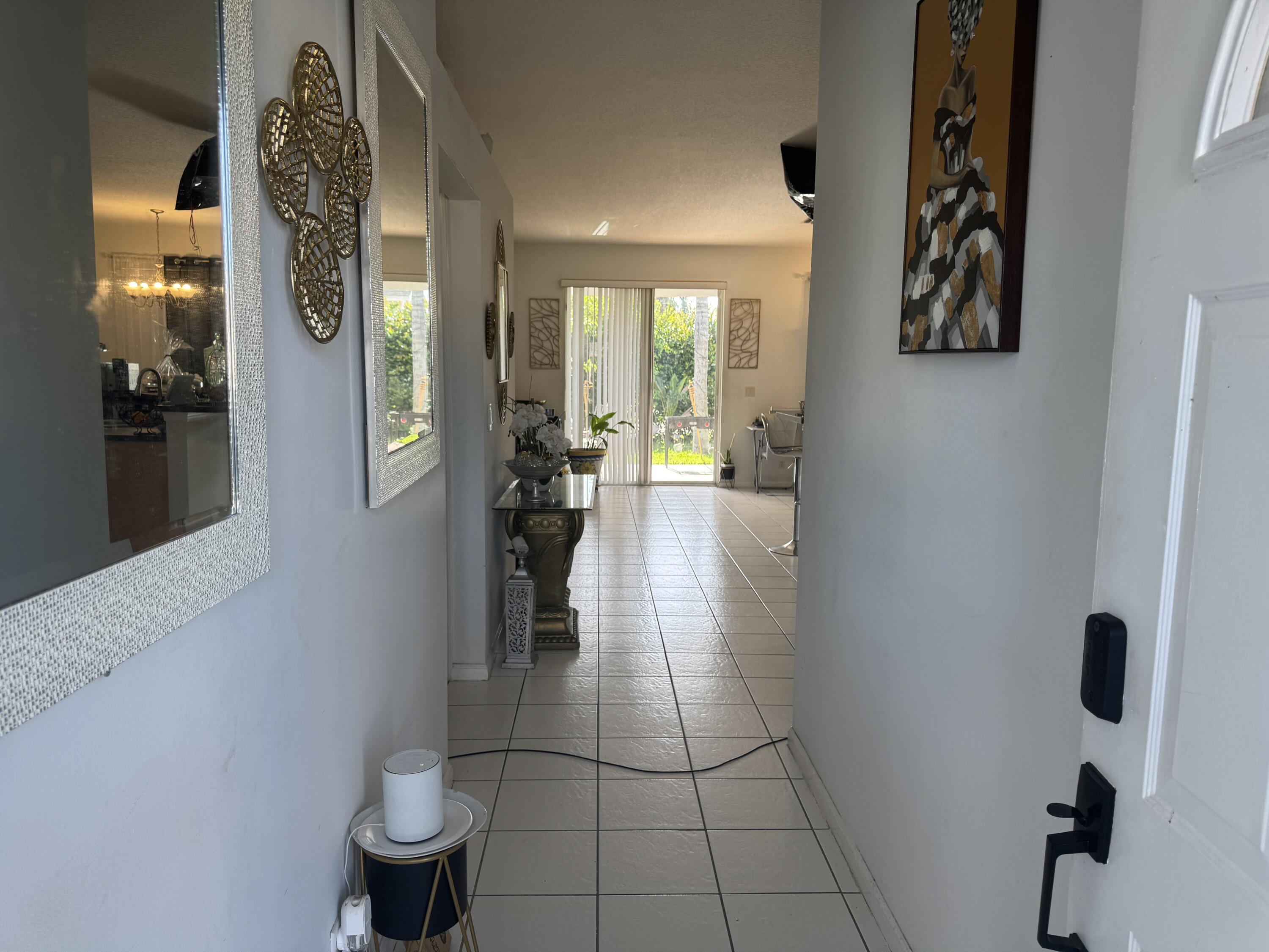 1011 Salmon Isle Greenacres, FL 33413 - Photo 7 of 28 view of hall way with mirror
