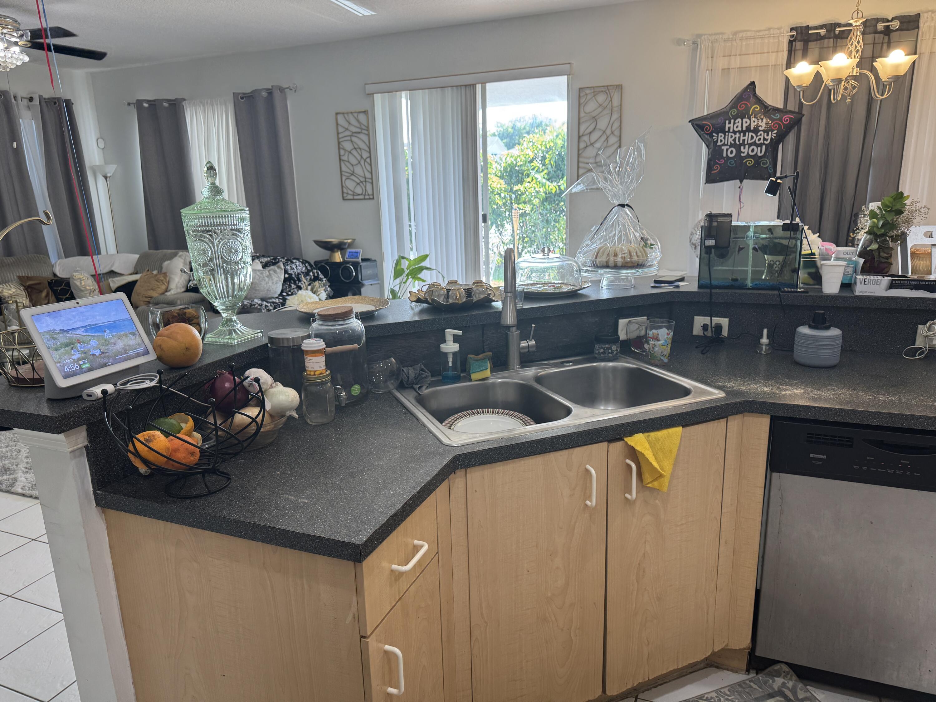 1011 Salmon Isle Greenacres, FL 33413 - Photo 10 of 28 a kitchen with a sink a counter and chairs