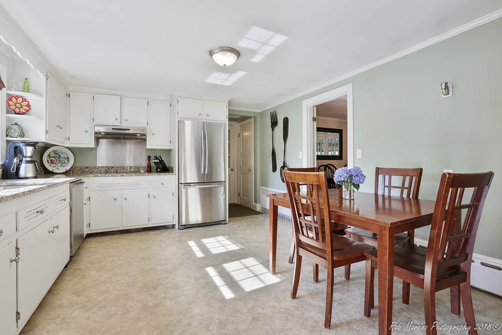 5 Cedarview Road Ipswich, MA 01938 - Photo 6 of 30 a kitchen with stainless steel appliances a table chairs and a refrigerator