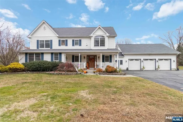 a view of a house with swimming pool and sitting area