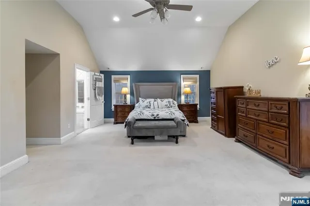 a spacious bedroom with a bed and dresser